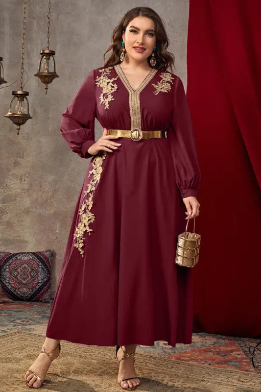 Burgundy long-sleeved A-line dress with gold embroidery and cinched waist