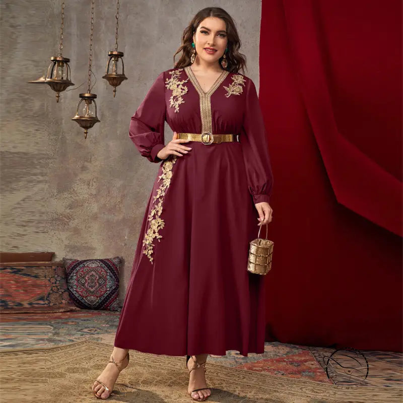 Burgundy long-sleeved A-line dress with gold embroidery and cinched waist