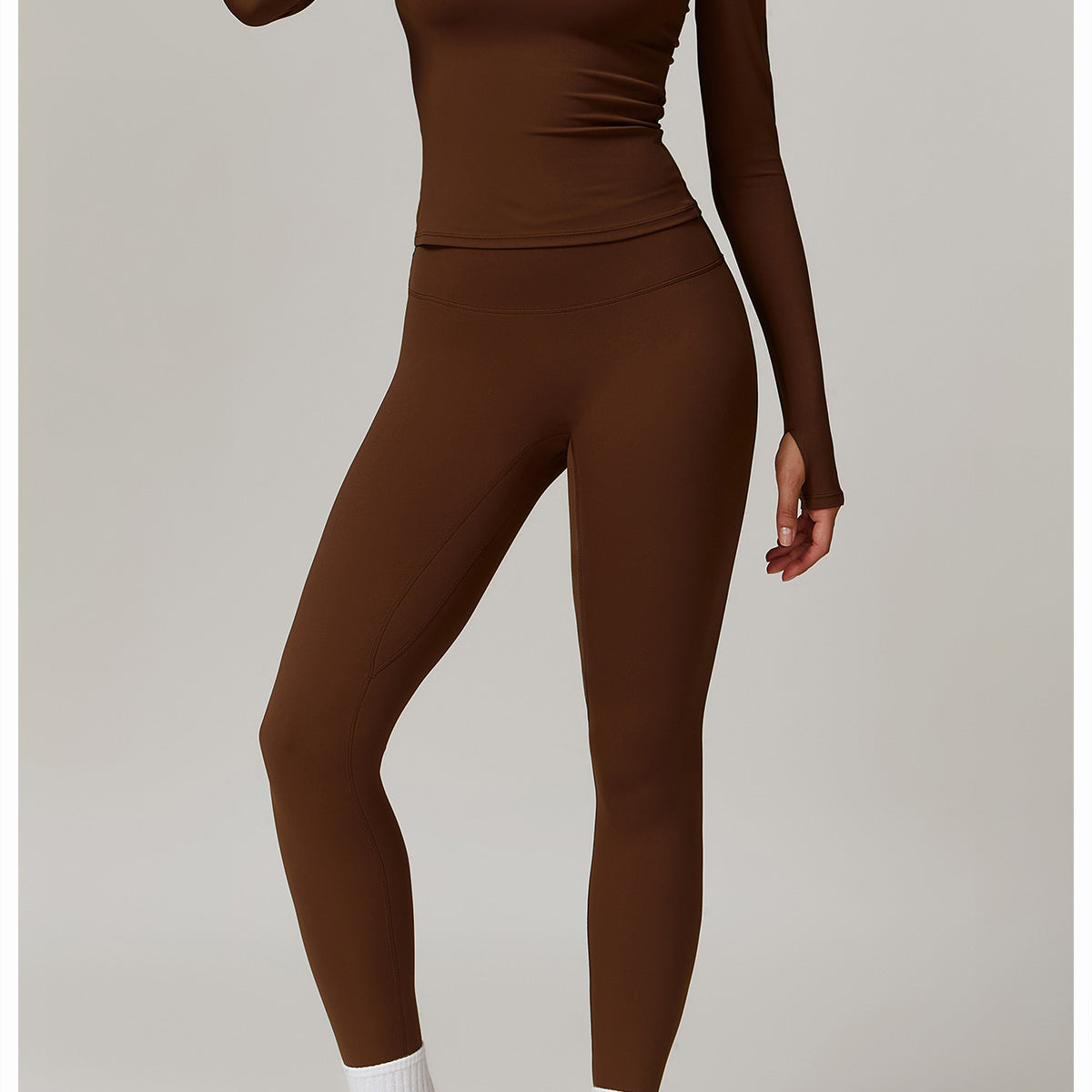 Brown long-sleeved athletic jumpsuit with white sneakers for langry outdoor fitness fashion