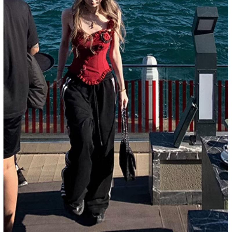 Red handmade lace boning corset with black pants and floral embellishments