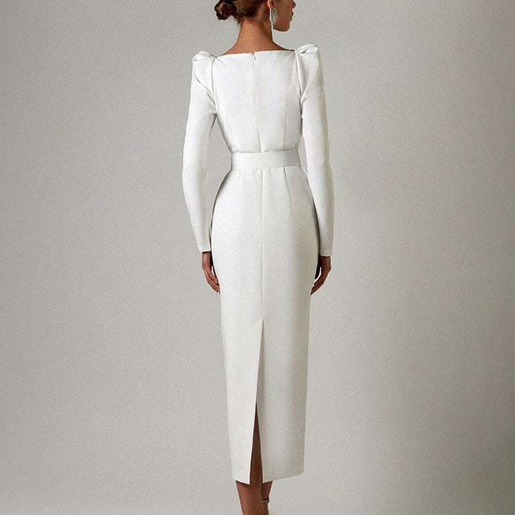 Elegant white long-sleeved dress with structured shoulders, ideal for fashion enthusiasts