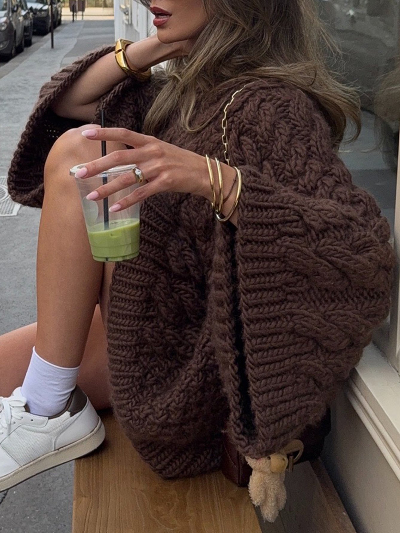 Brown chunky knit oversized long sleeve sweater with pom-pom hem