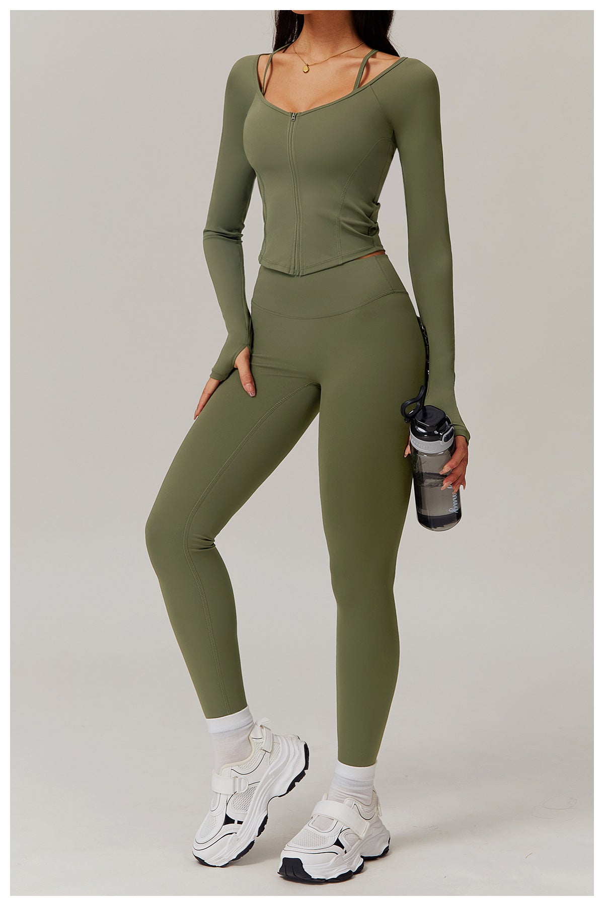 Olive green fitted jumpsuit paired with chunky white sneakers for comfy fashion ملابس