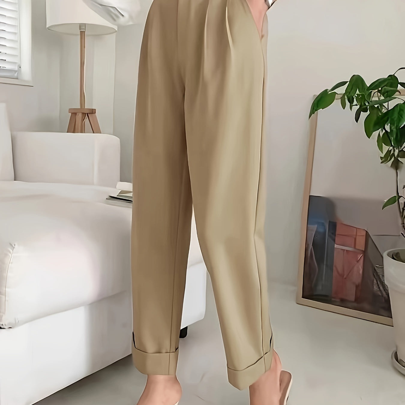 High-waisted beige pleated trousers with rolled cuffs in wide leg pant style