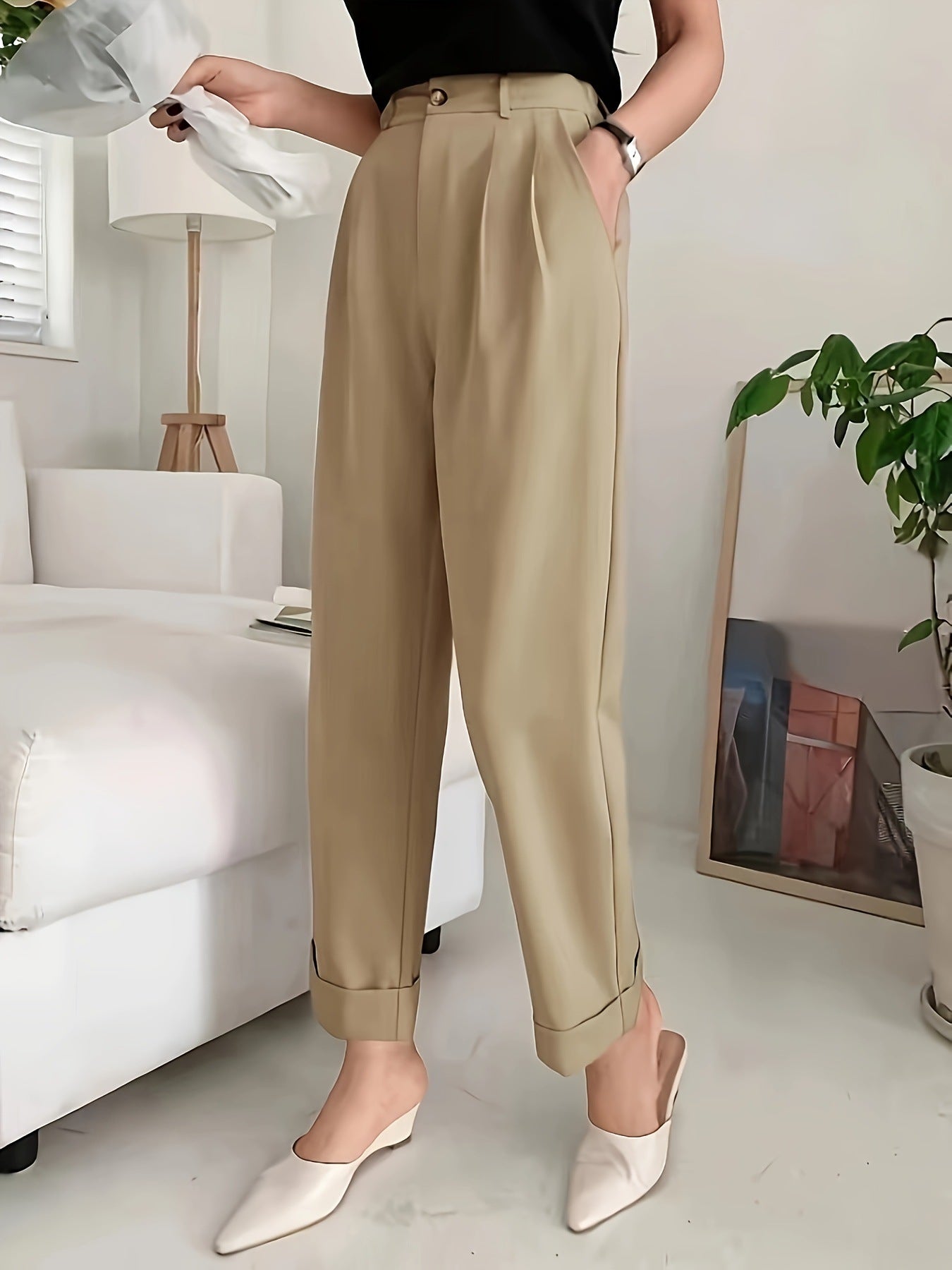 High-waisted beige pleated trousers with rolled cuffs in wide leg pant style