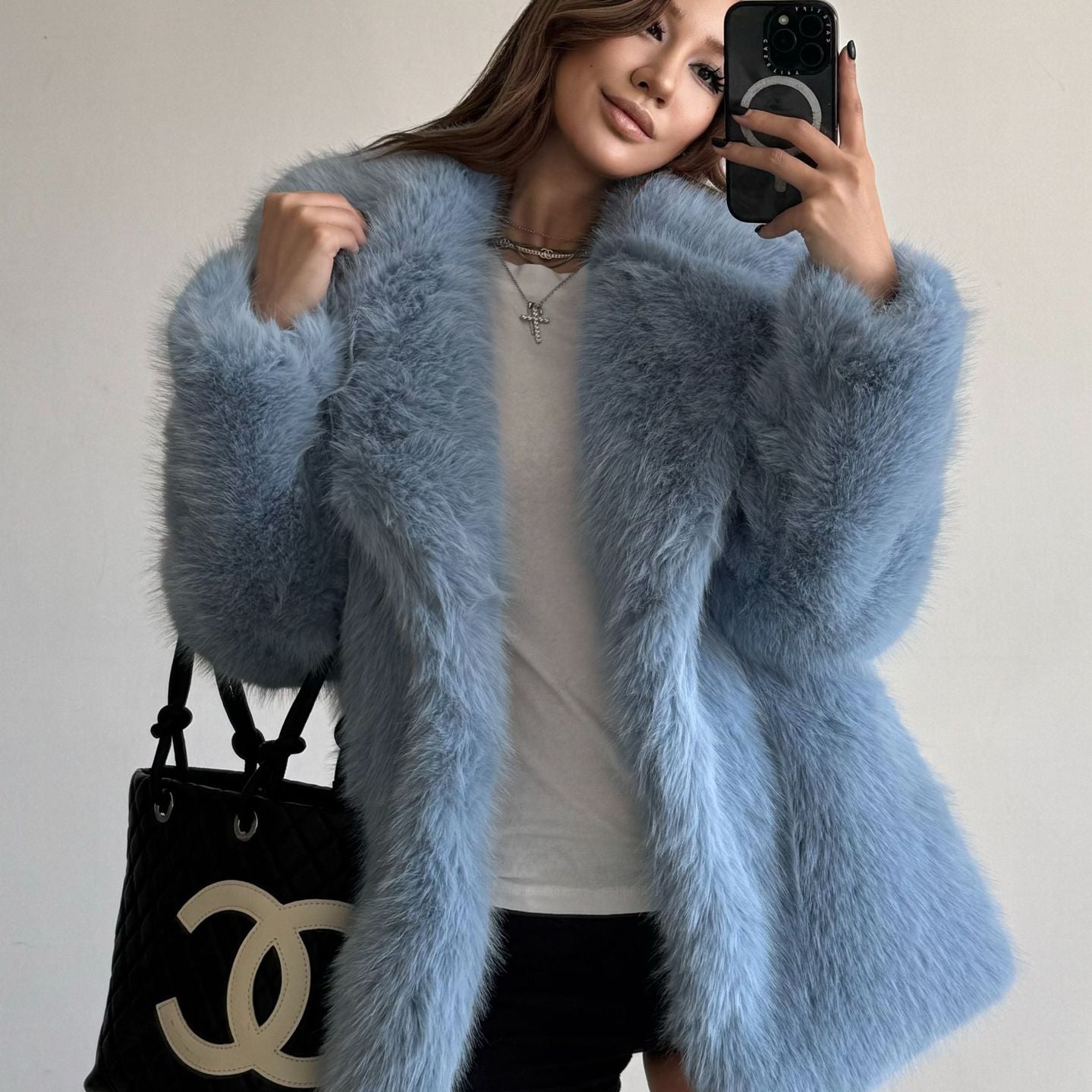 Light blue fluffy faux fur coat with Chanel handbag