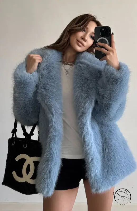 Light blue fluffy faux fur coat with Chanel handbag