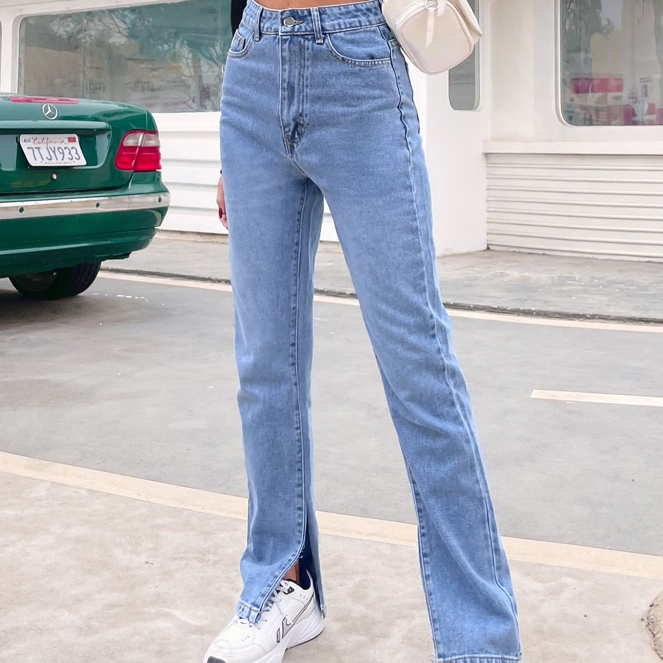 Light blue high-waisted denim pants with split flared hems, stylish Langry fashion choice