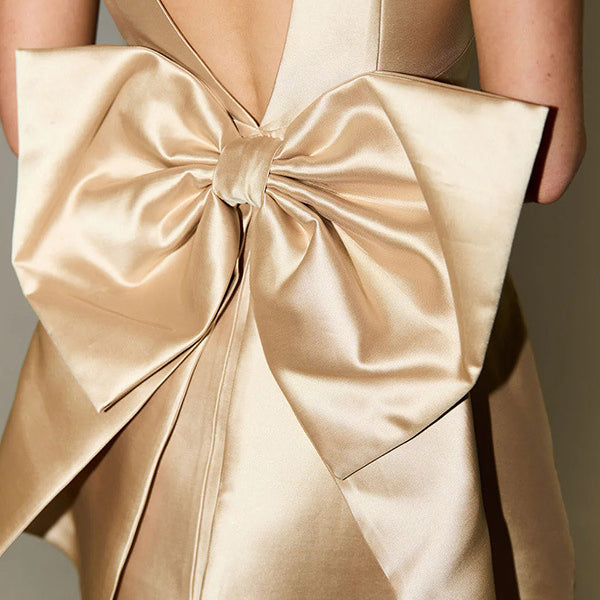 Champagne-colored satin bow on fabric of Captivating Bow Decorative Dress, elegant fashion ملابس