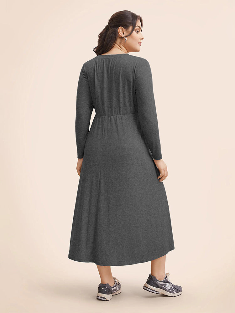 Winter loose long gray midi dress with elastic waist paired with athletic sneakers for fashion
