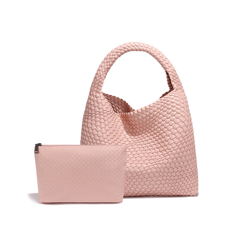 Pink woven handbag with matching pouch, a stylish choice for fashion enthusiasts