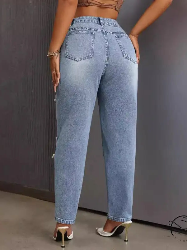 Slimming skinny ripped jeans in light wash distressed denim with side pearl embellishments