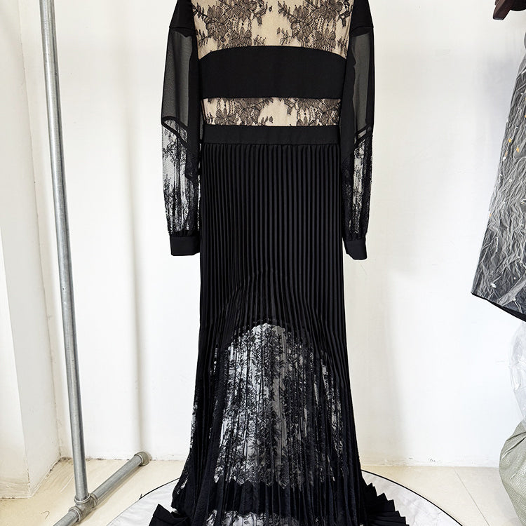 Elegant long black pleated dress with lace accents showcasing luxury fashion style