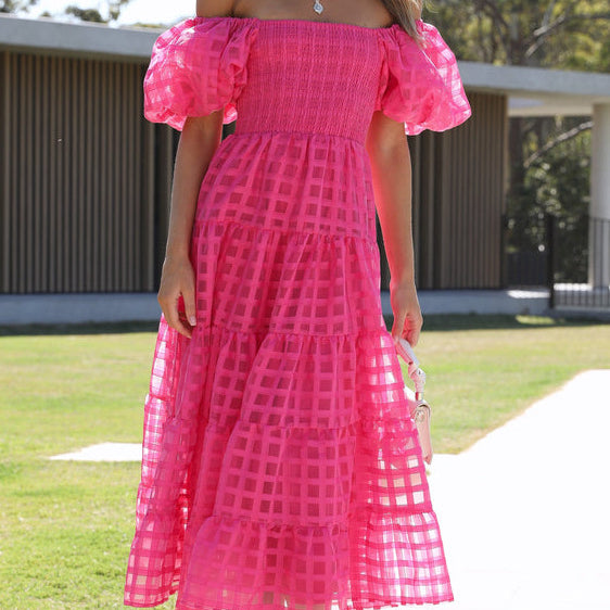 Woman in a pink off-the-shoulder Enchanting Lantern Sleeve Dress showcasing trendy fashion ملابس