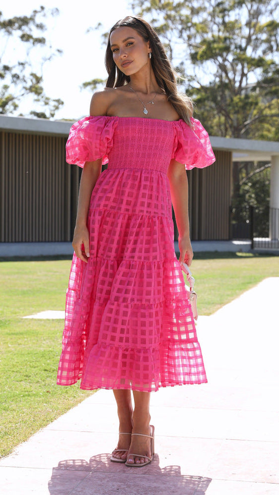 Woman in a pink off-the-shoulder Enchanting Lantern Sleeve Dress showcasing trendy fashion ملابس
