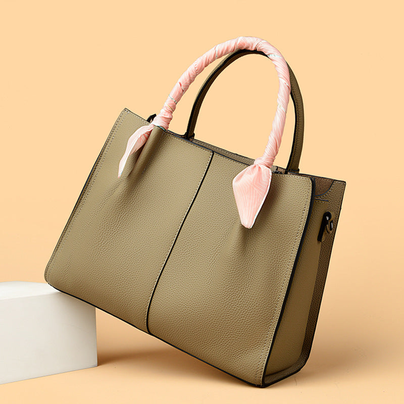 Elegant Langry olive green leather tote bag with pink bow handles