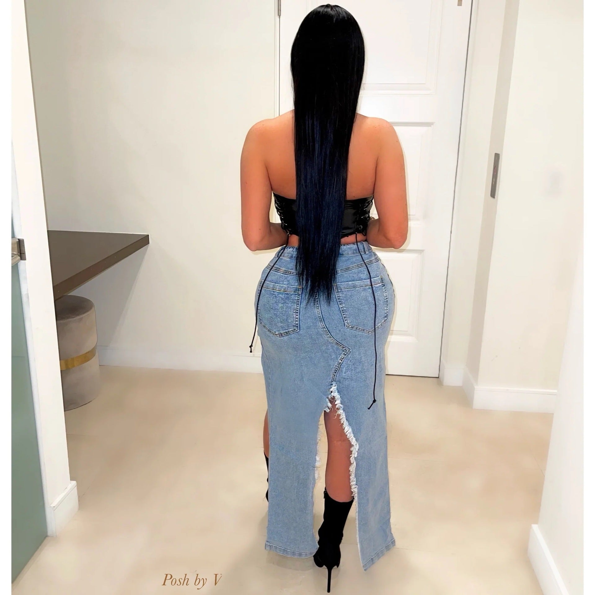 Long straight black hair paired with a stylish ripped denim maxi skirt in fashion ملابس