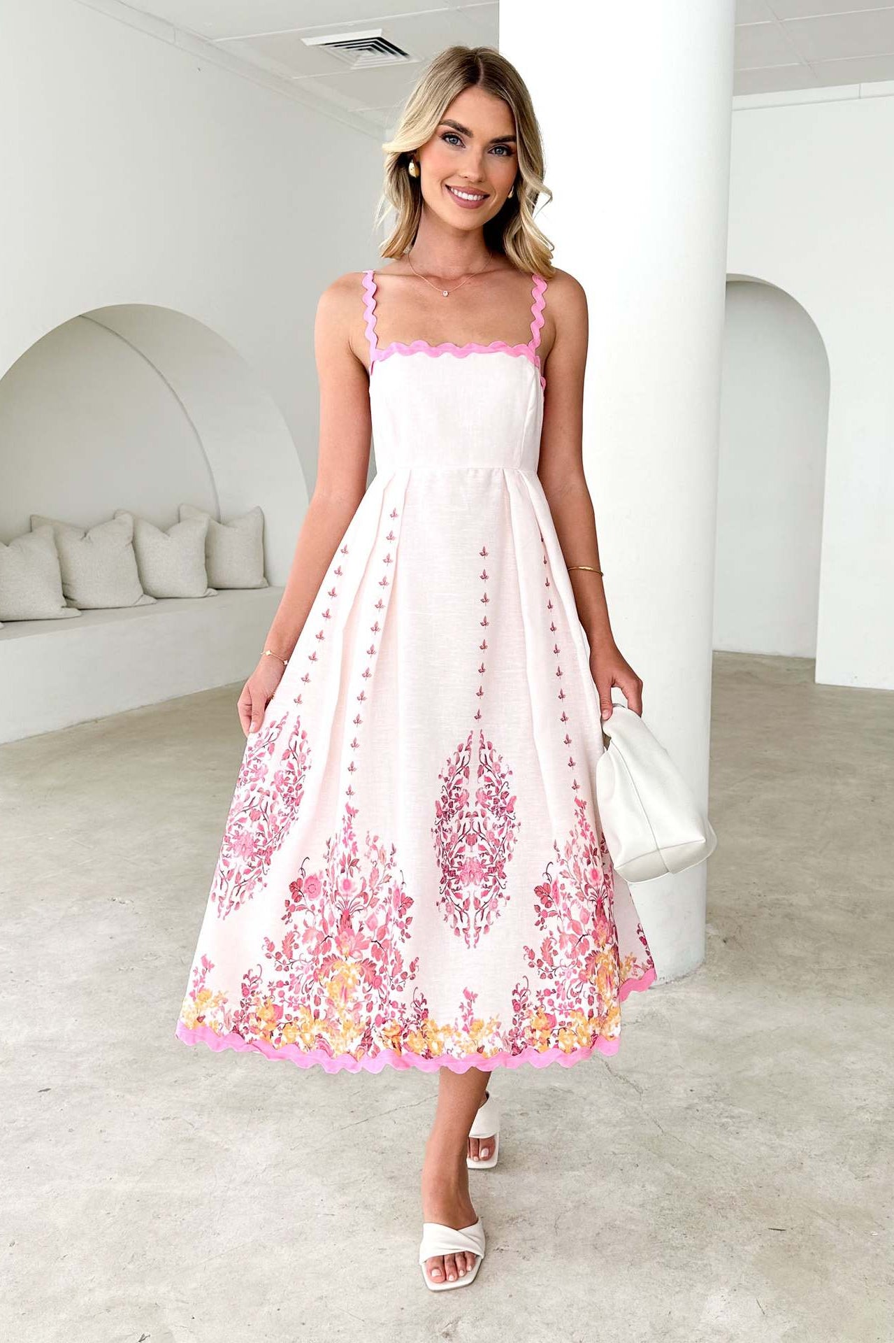 White sundress with pink floral embroidery, perfect for summer fashion and ملابس style
