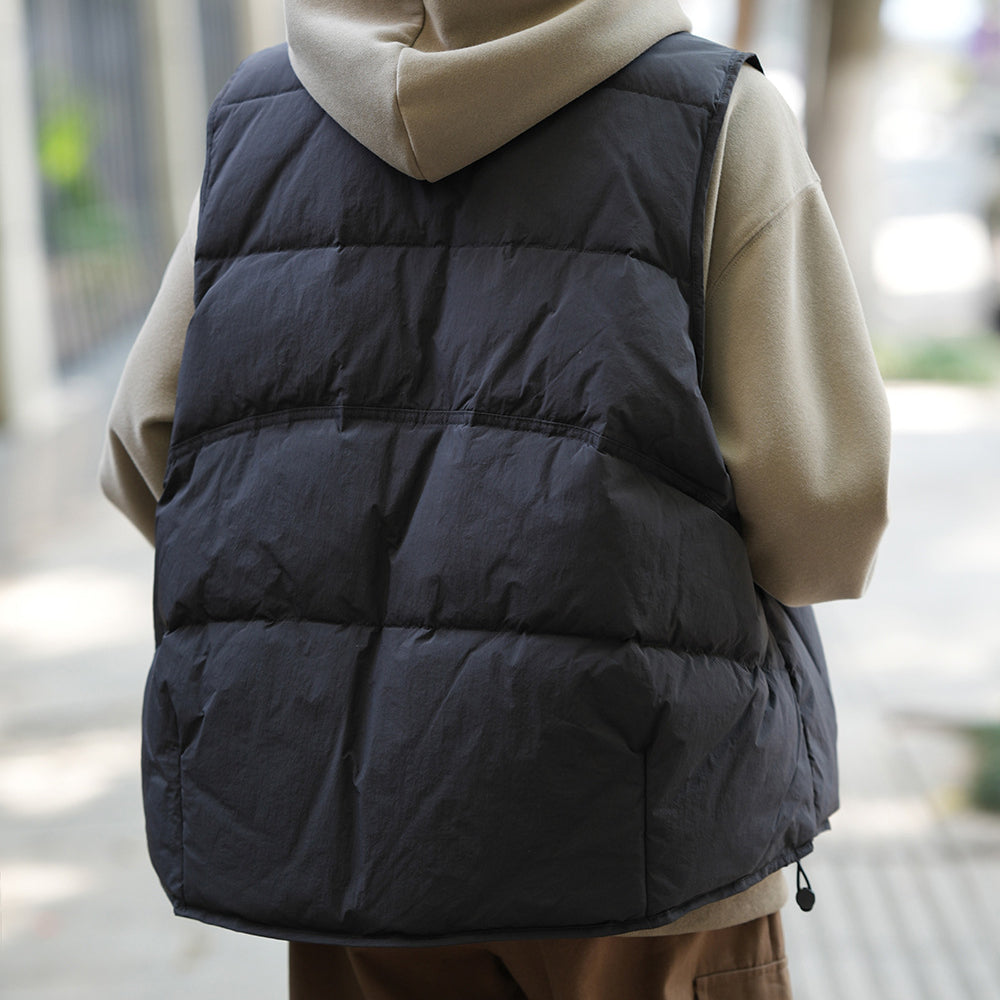 Black puffy winter vest over beige hoodie, ideal for Langry fashion ملابس in cold weather