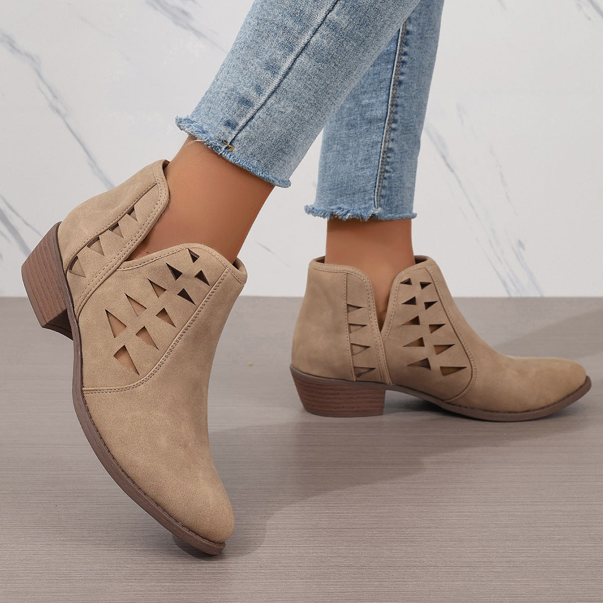 Beige suede daily ankle boots featuring geometric cutout details and low wooden heels