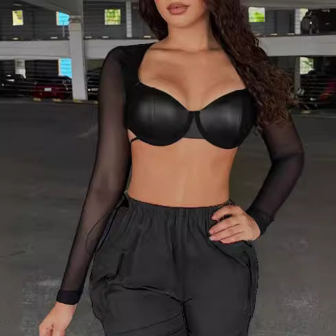 Woman wearing short cropped faux leather tied long sleeves mesh top with black cargo pants
