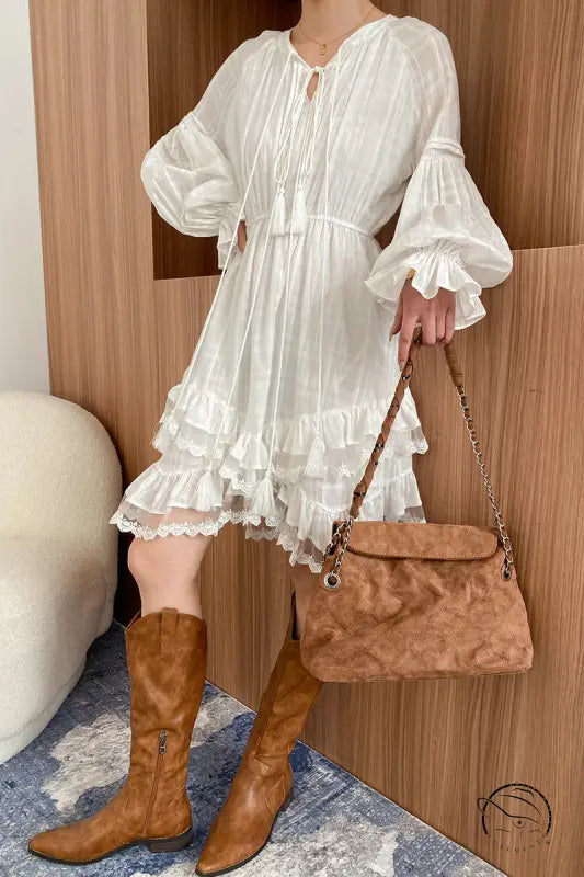 Stunning layered dress in white ruffles with brown boots and handbag