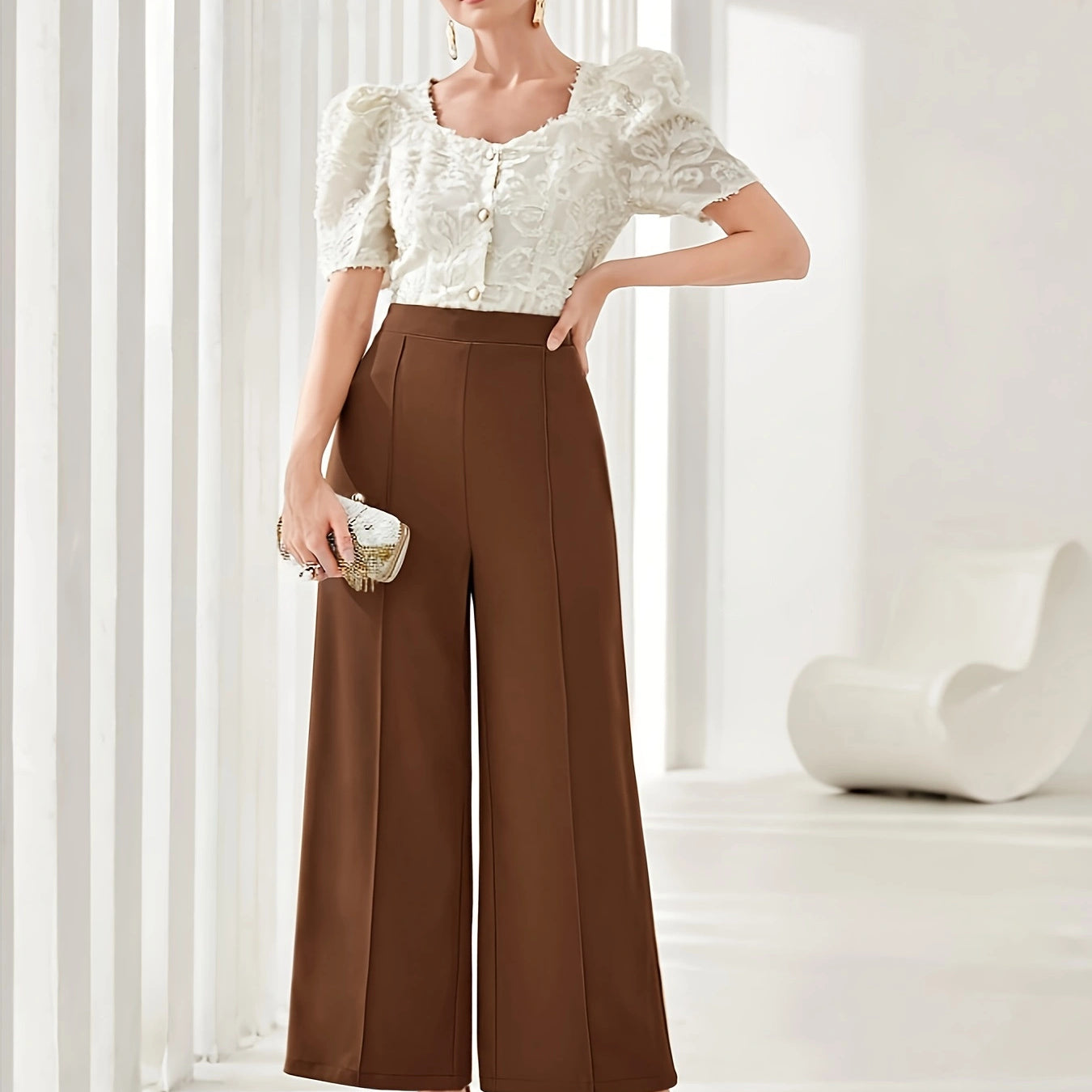 High-waisted brown palazzo pants with a white puff-sleeve crop top in elegant fashion