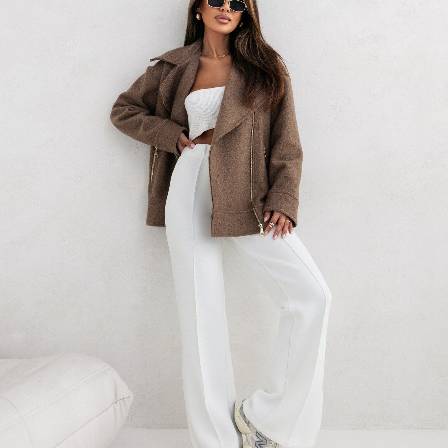 Woman in brown jacket and white pants showcasing Langry fashion ملابس style