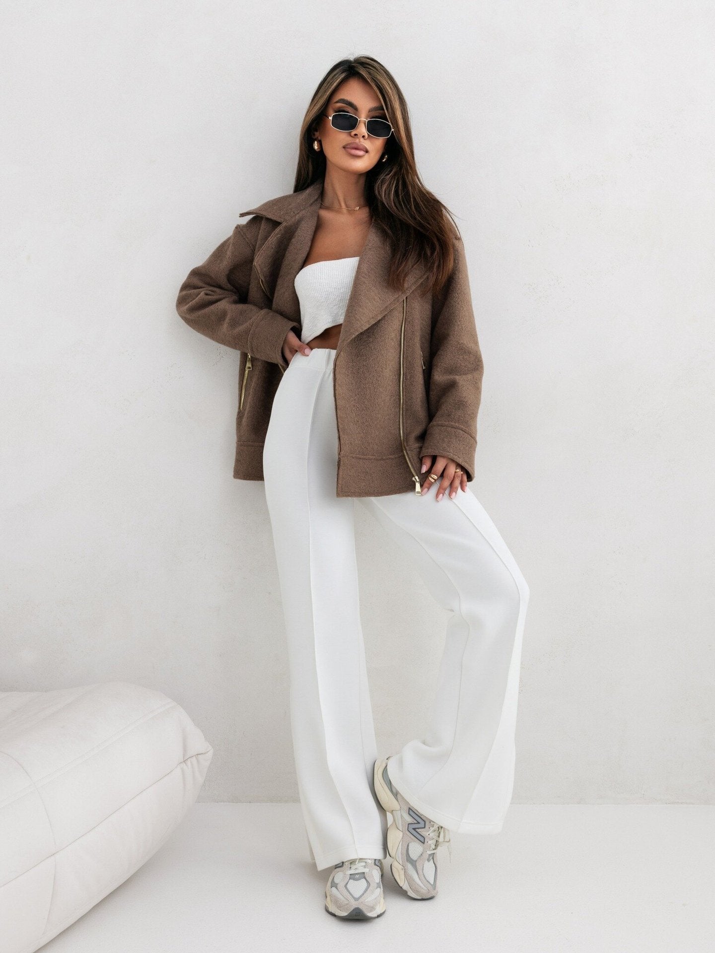 Woman in brown jacket and white pants showcasing Langry fashion ملابس style