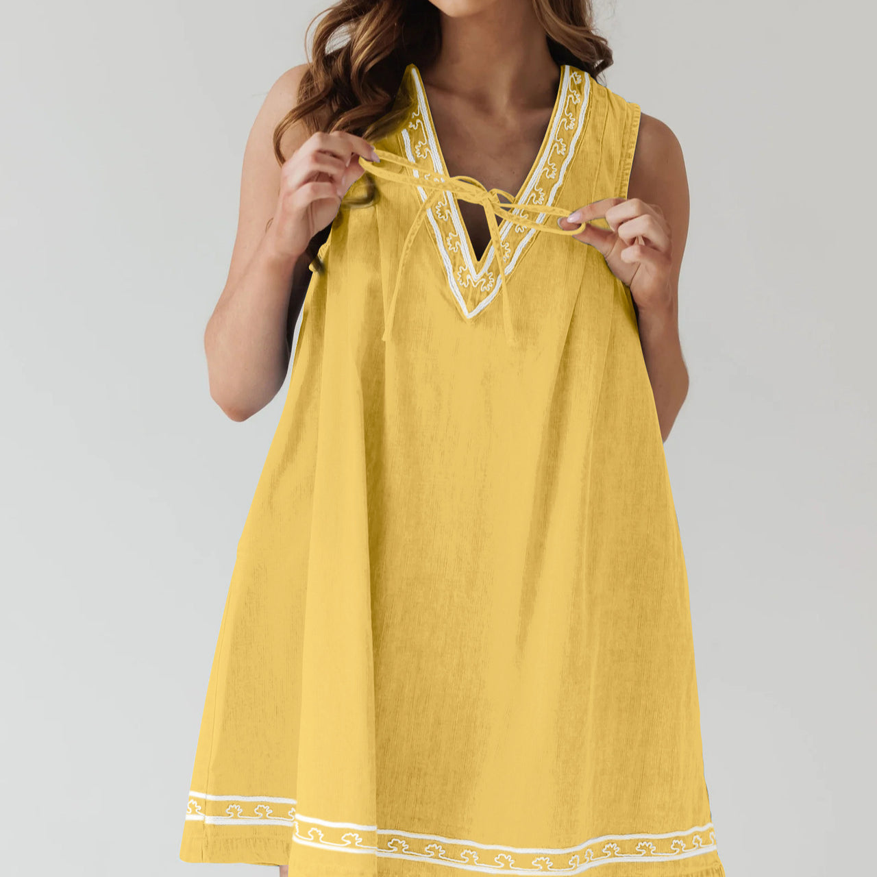 Yellow sleeveless dress with white trim, part of the Beautiful Embroidered Vest Denim Dress collection