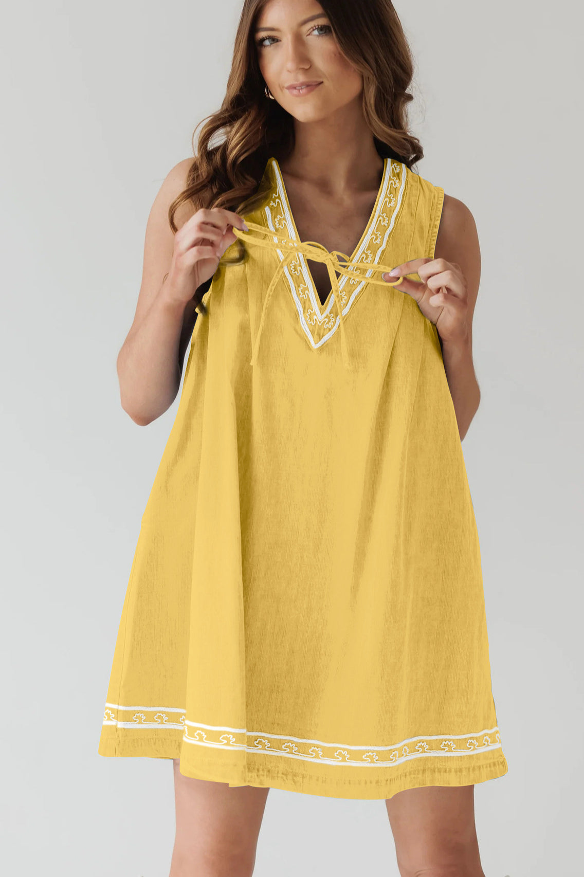 Yellow sleeveless dress with white trim, part of the Beautiful Embroidered Vest Denim Dress collection