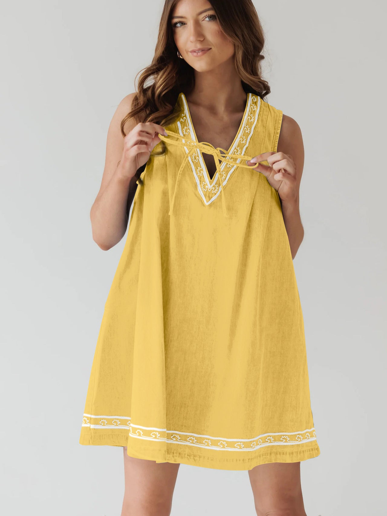 Yellow sleeveless dress with white trim, part of the Beautiful Embroidered Vest Denim Dress collection