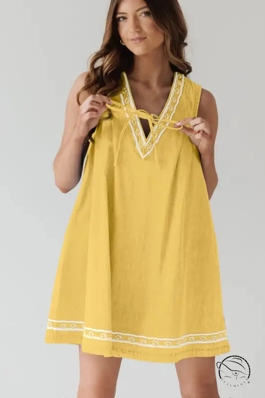 Beautiful embroidered vest denim dress in yellow with white trim
