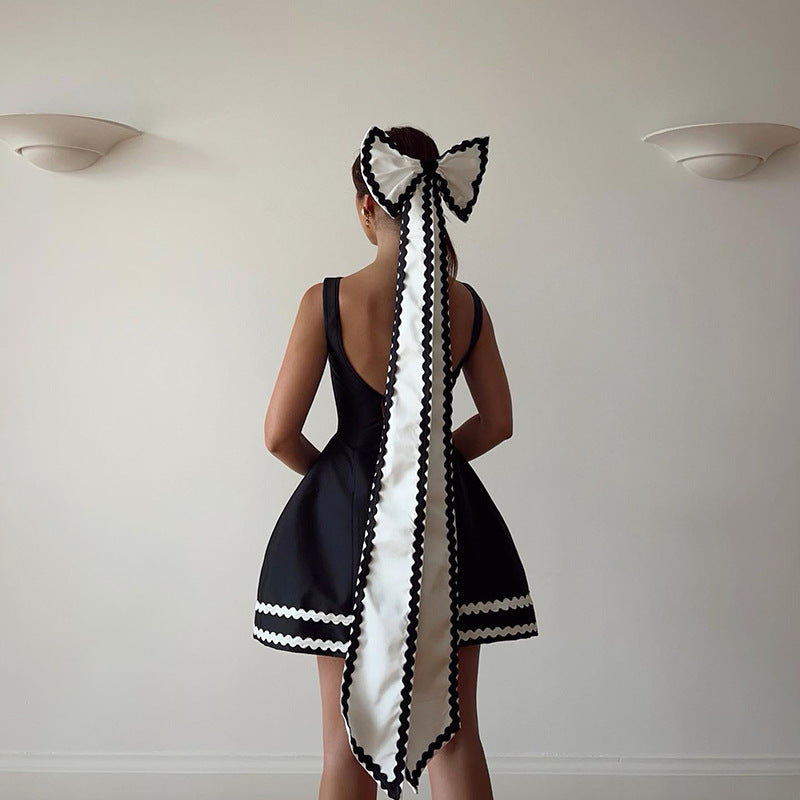 Elegant black and white line dress with matching bow, perfect for summer socialite fashion