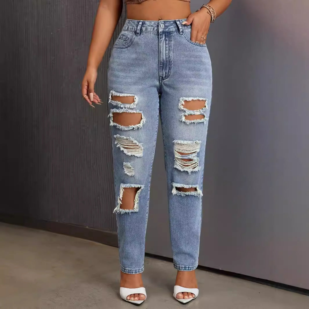 Light blue distressed women’s slimming skinny ripped jeans with multiple tears