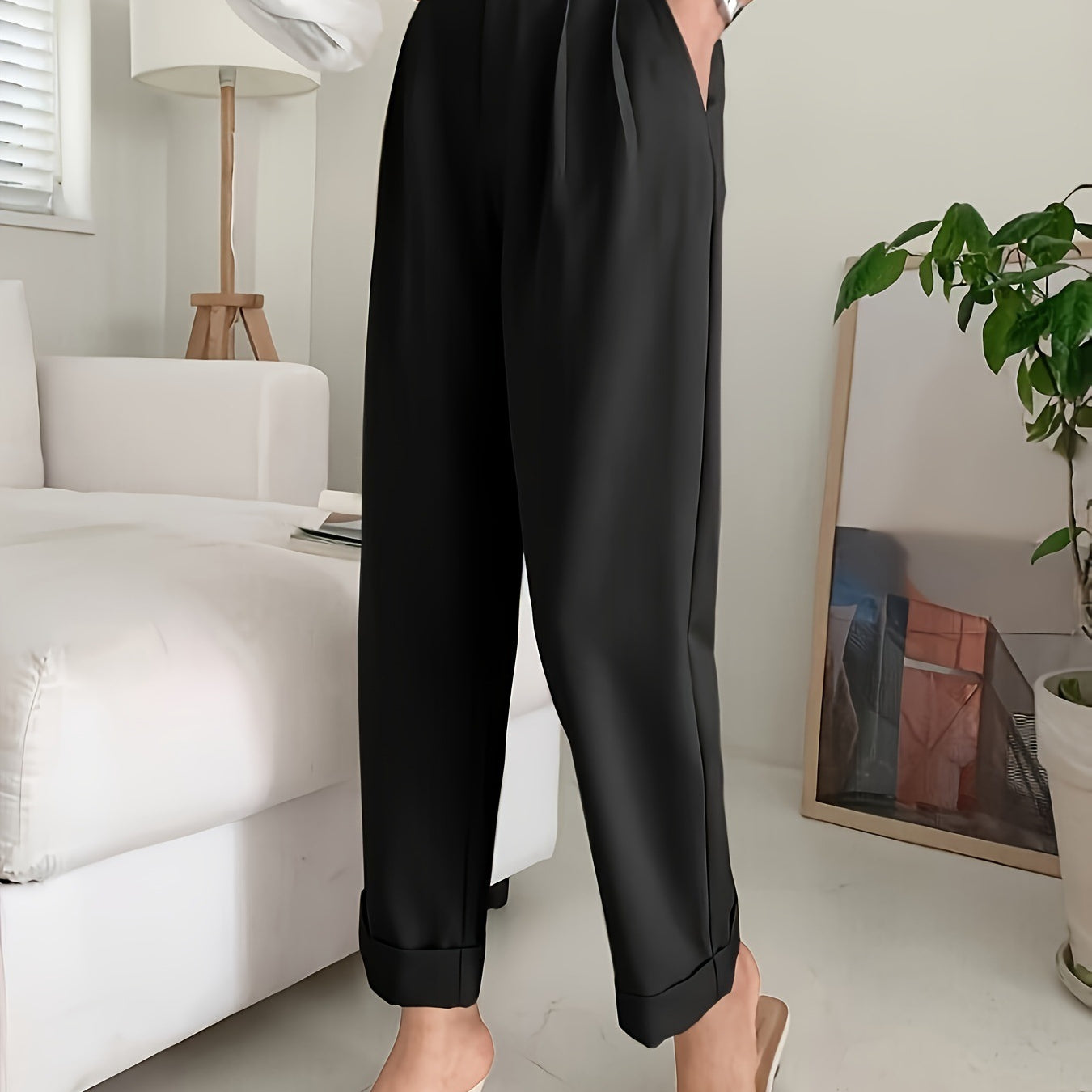 Elegant black pleated wide leg pant styled with pointed white mules for a chic look