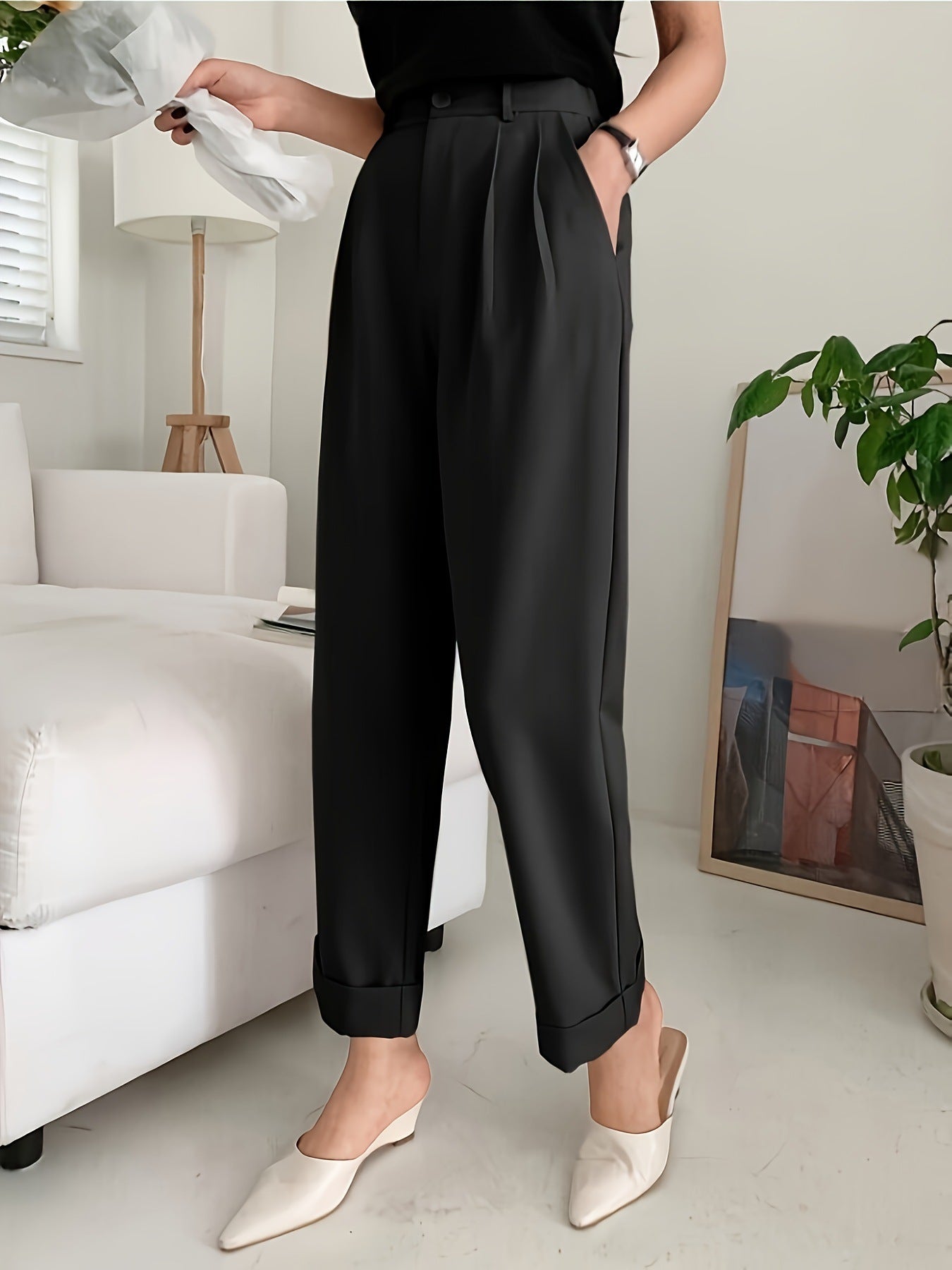 Elegant black pleated wide leg pant styled with pointed white mules for a chic look