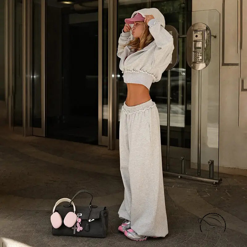 Black leather handbag with pink earmuff charms on langry fashion jacket suit