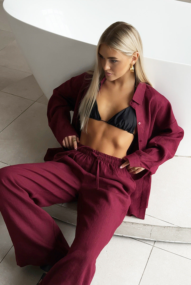 Burgundy linen pantsuit with black bikini top, perfect for fashionable casual sets