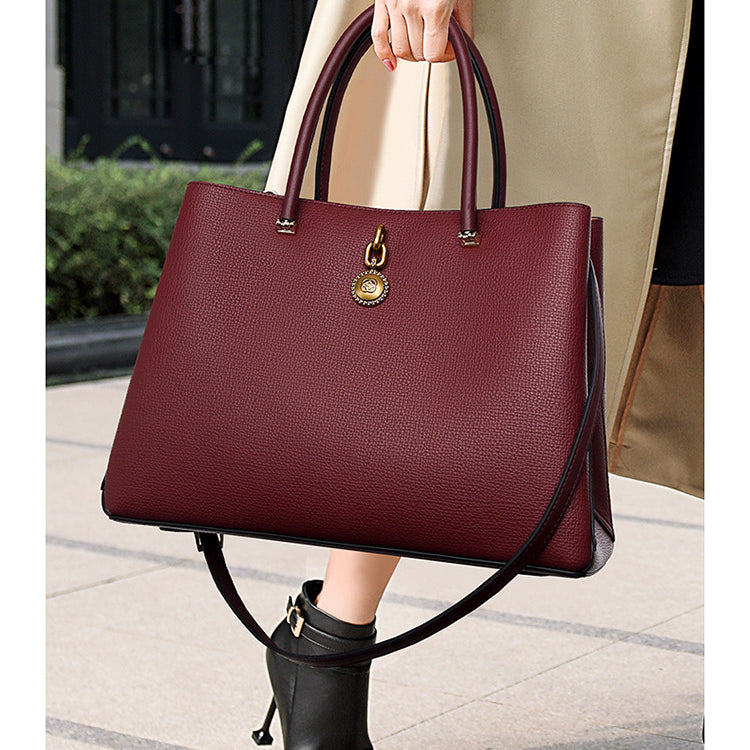 Burgundy leather handbag with gold hardware, a stylish choice for high-grade fashion ملابس
