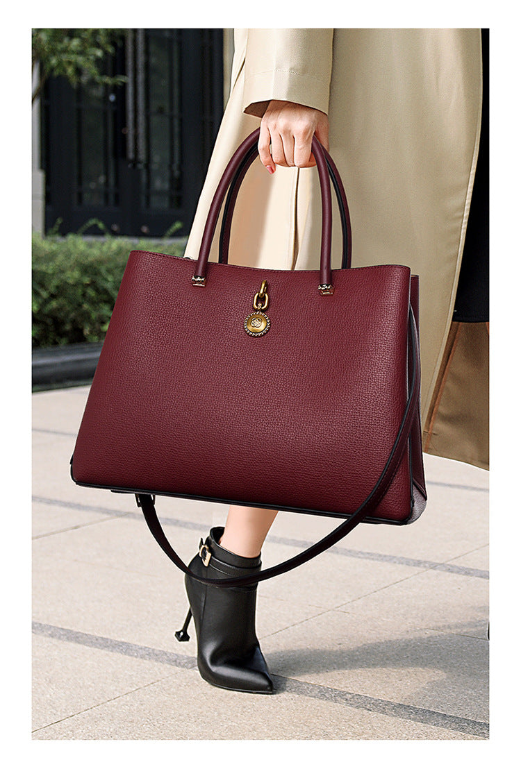 Burgundy leather handbag with gold hardware, a stylish choice for high-grade fashion ملابس