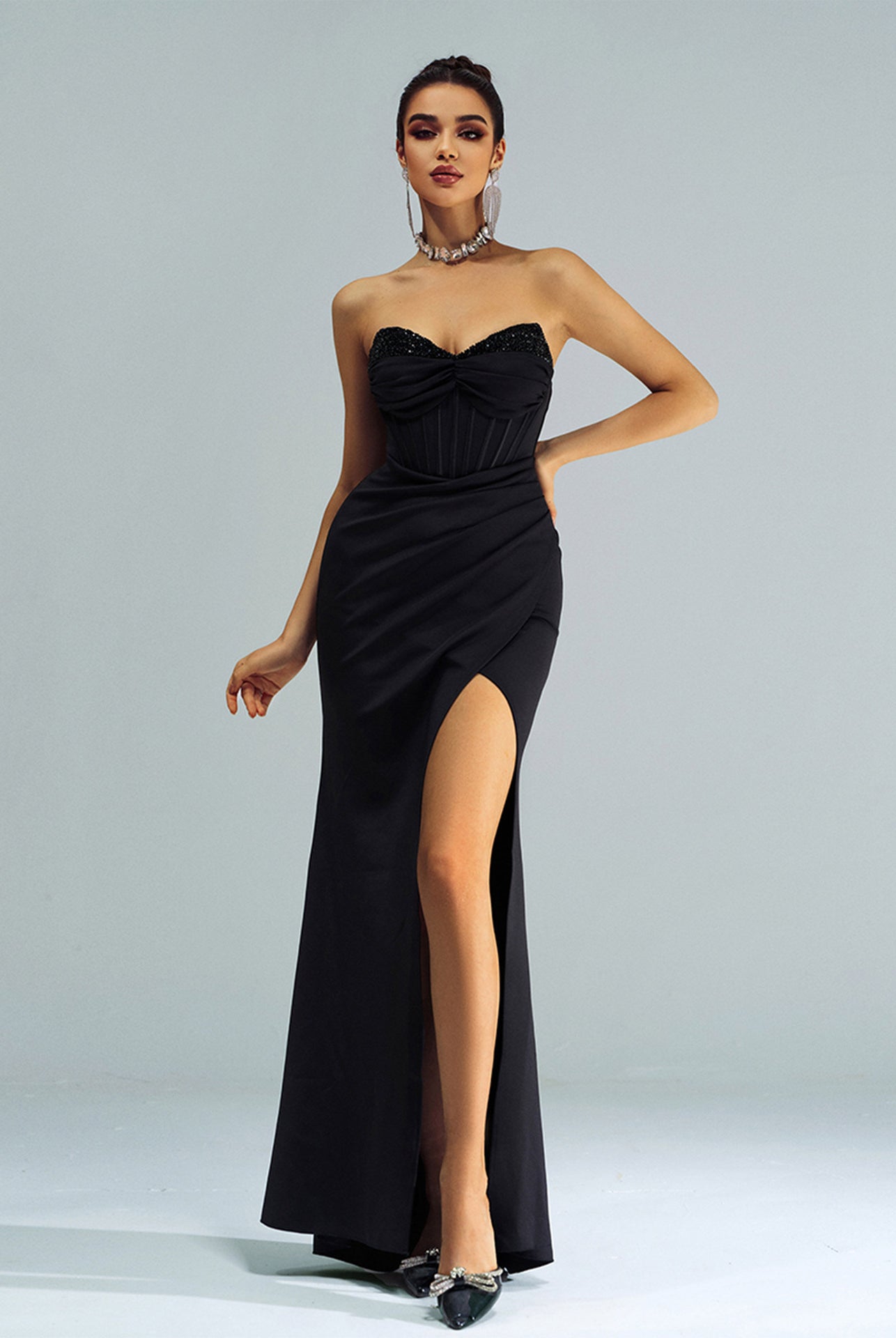 Elegant black strapless evening gown with high side slit, a stunning addition to fashion ملابس