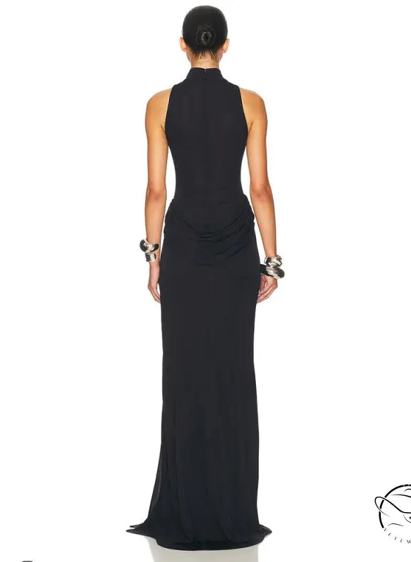Black halter neck maxi dress with tight waist, high split, ruched detailing, and silver hardware