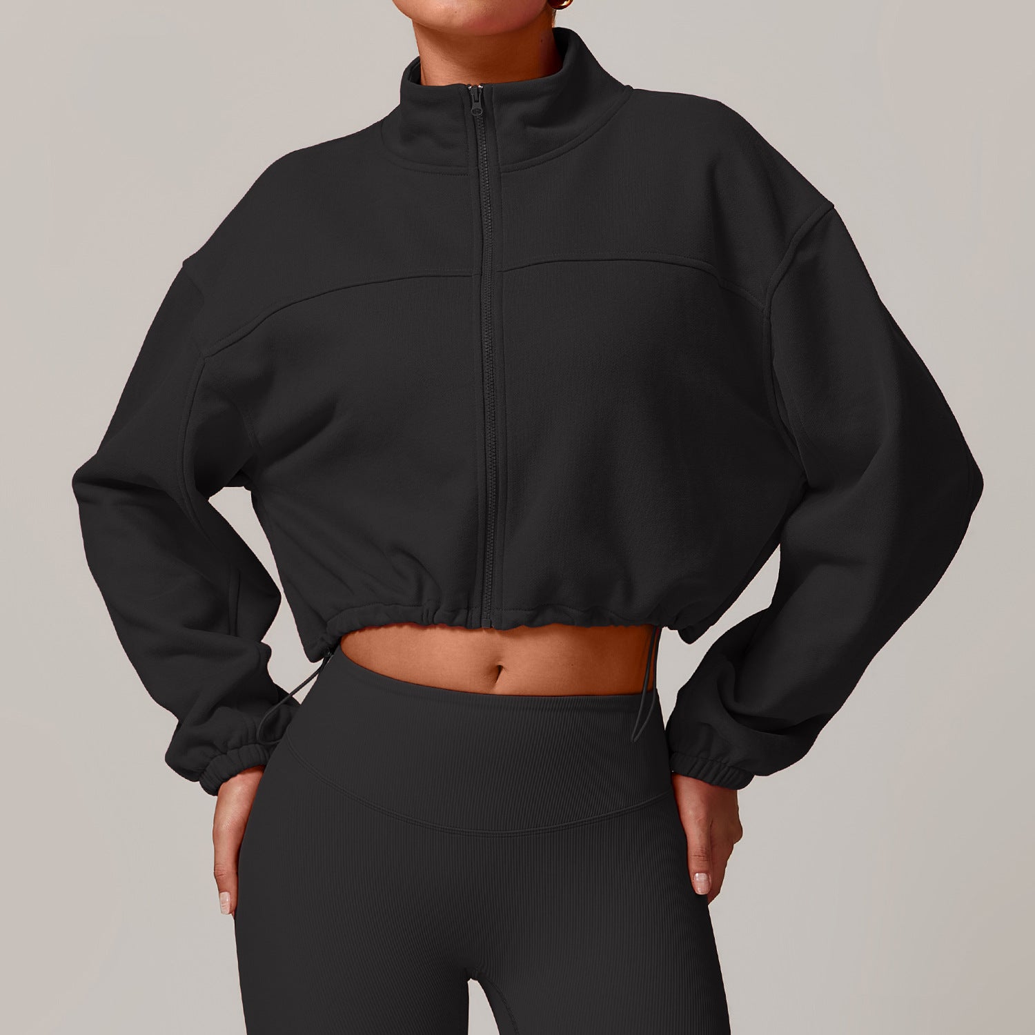 Black cropped zip-up athletic jacket with balloon sleeves for fashion-forward fitness wear