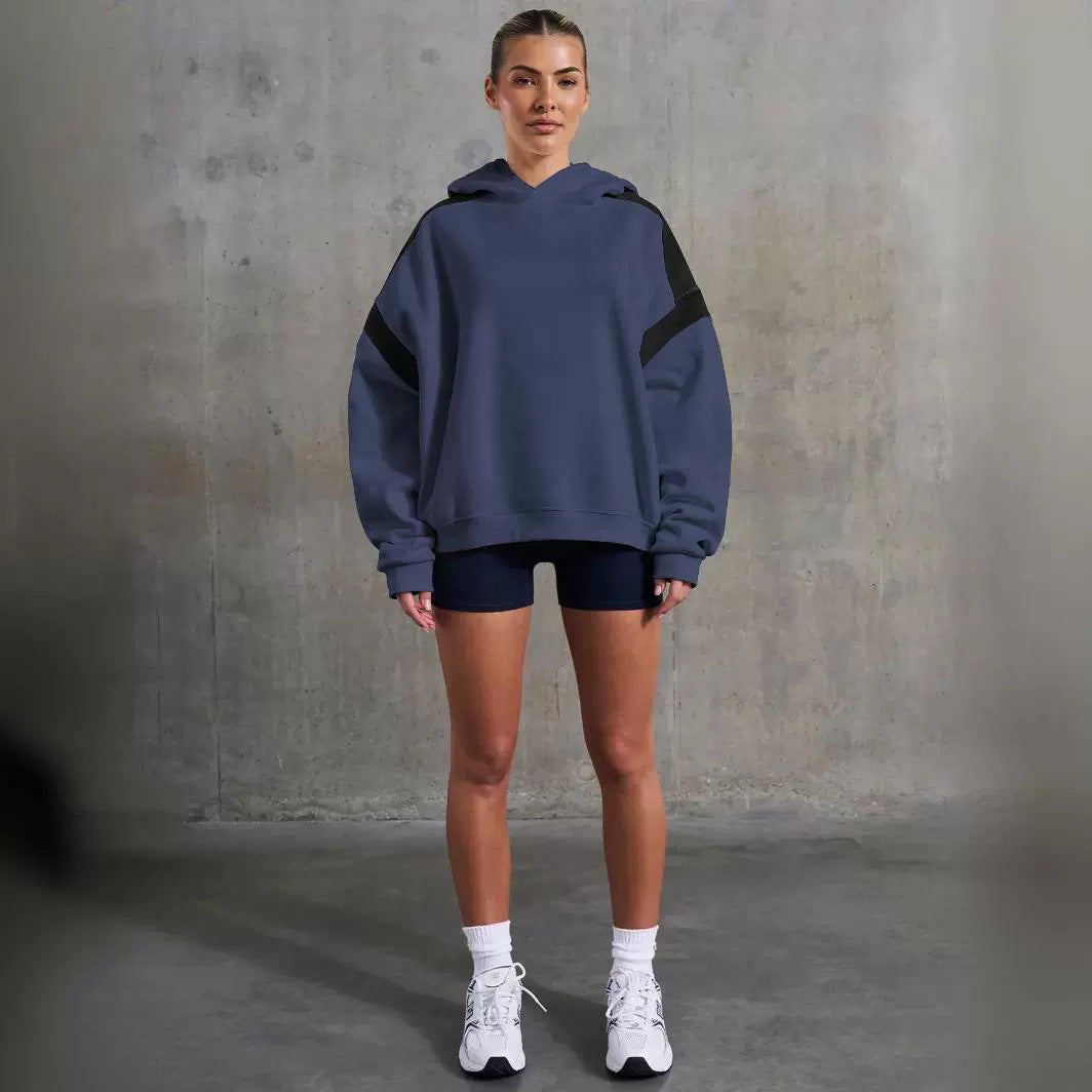 Woman in blue hoodie and black shorts showcasing Langry fashion style