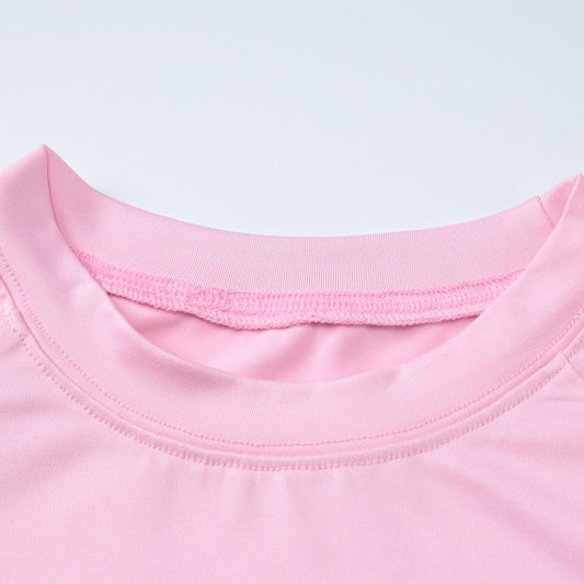 Pink crew neck shirt paired with slim fit high waist suit for a stylish look