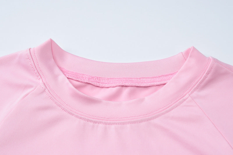 Pink crew neck shirt paired with slim fit high waist suit for a stylish look