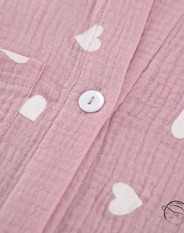 Pink crinkle cotton pajamas set with white heart patterns and button