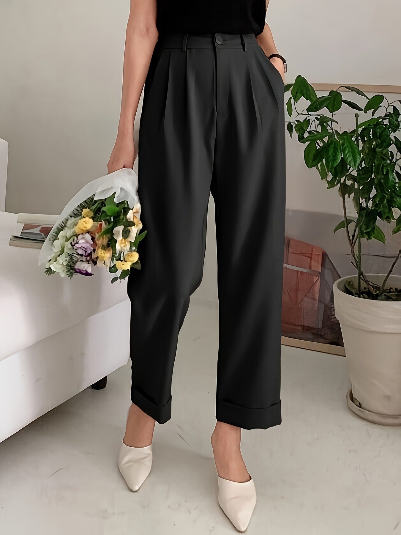 High-waisted black pleated trousers with cream pointed flats, perfect wide leg pant style