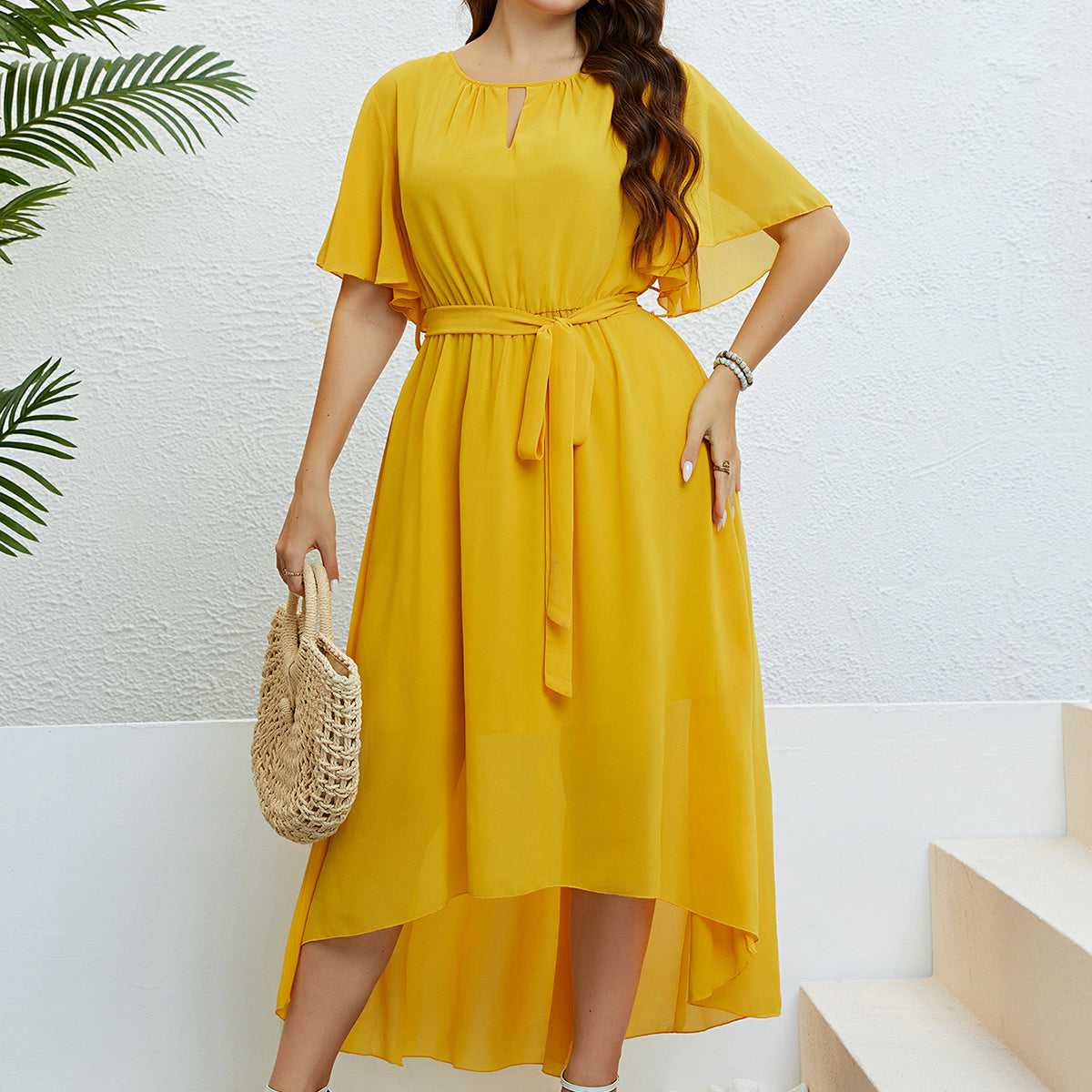 Woman in a yellow high-low dress showcasing elegant lace with free shipping at Langry